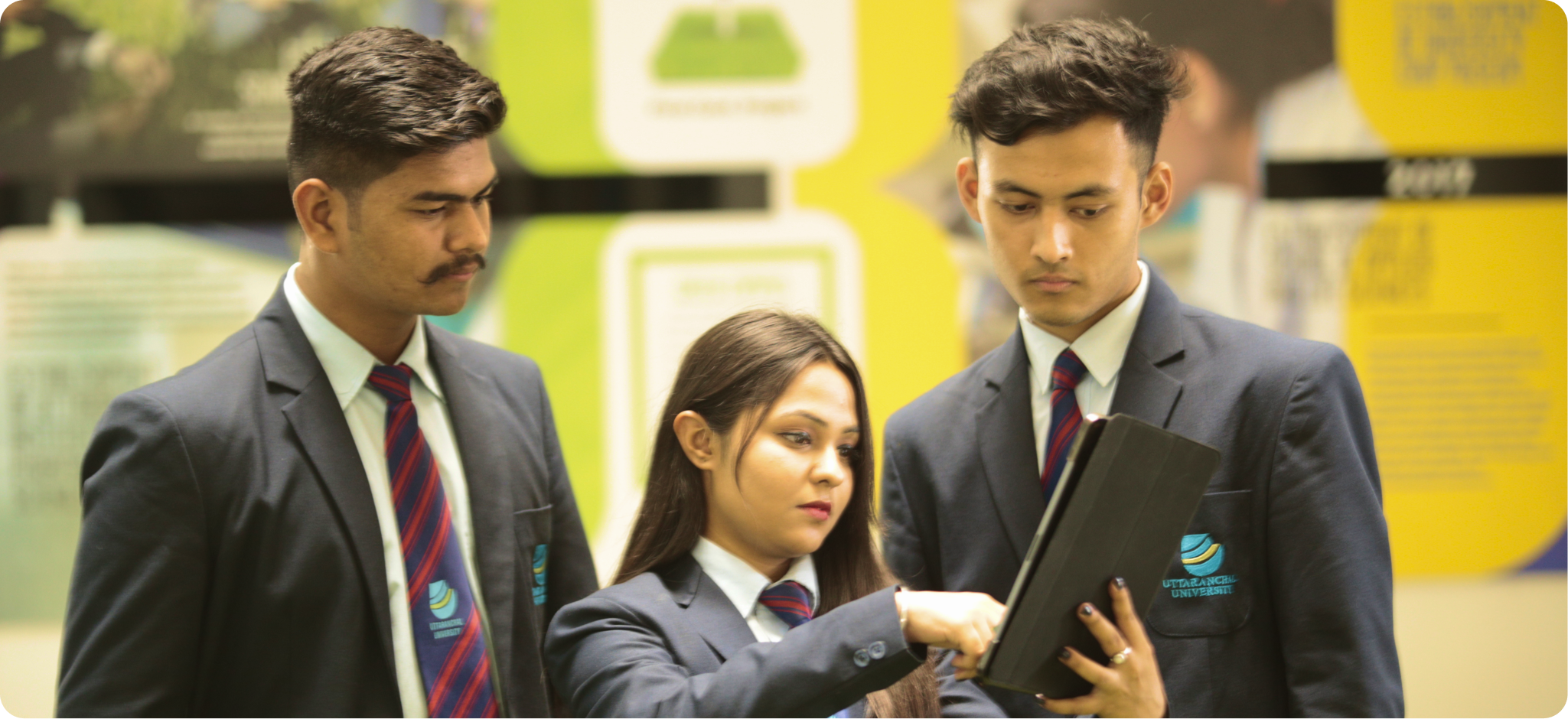 Uttaranchal University students collaborating with a tablet